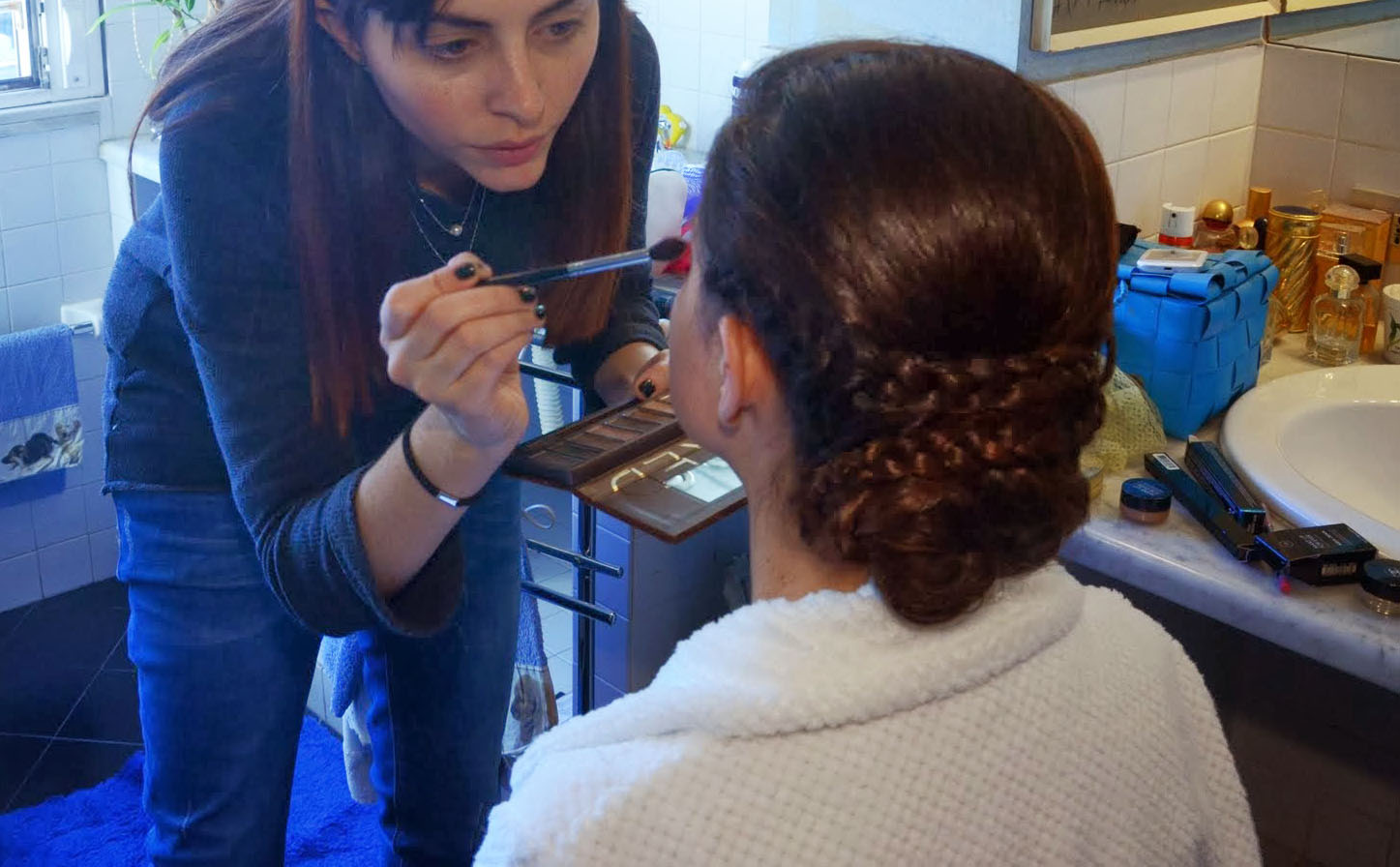 Foto di Elio Costantini (tagliata malamente da me) che ritrae una donna sfatta che trucca una donna meravigliuosa. Notare l'acconciatura, deh